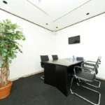 Sala de atendimento da Ji Consulting, com mesa de reunião e quatro cadeiras